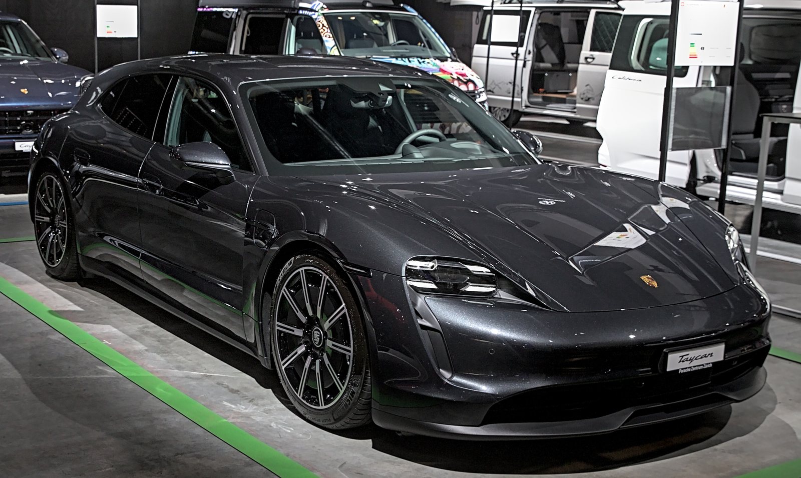 Porsche Taycan Sport Turismo in dark grey metallic, front three-quarter view